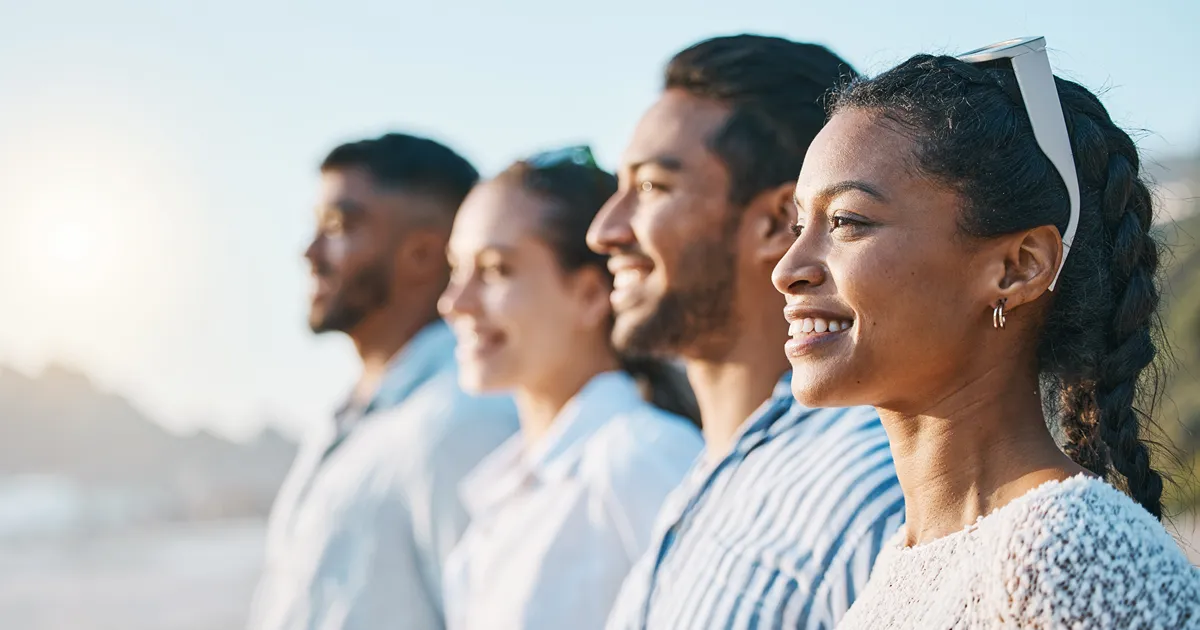 Bipolar disorder treatment: group of friends smiling outdoors in the sunlight