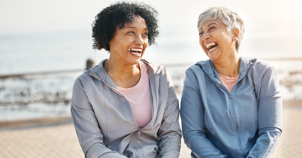 Bipolar treatment: two women laughing together on the beach